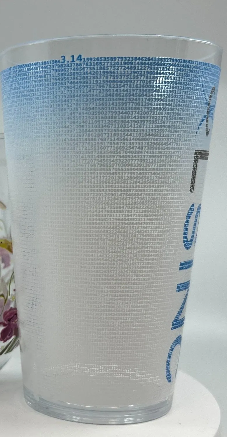 A clear glass tumbler printed with a gradient pattern and logo